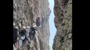 Os alpinistas ficaram suspensos na montanha, enquanto esperavam os outros avançarem nos degraus de metal que são presos à montanha.